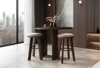 A modern wooden stool with fabric upholstery beside a wooden round table in a traditional room setting.