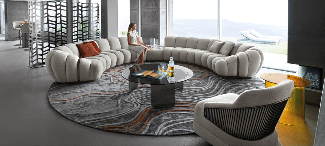 Large round luxury rug around a cozy couch
