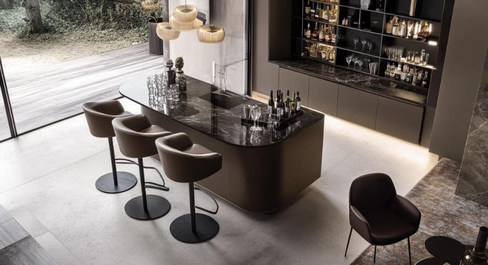 Stylish dark brown leather-upholstered bar stool placed with a luxurious gloss bar counter, creating a refined look. 