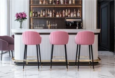 Classy pink bar stools enhancing the white bar counter with a bold contrast.