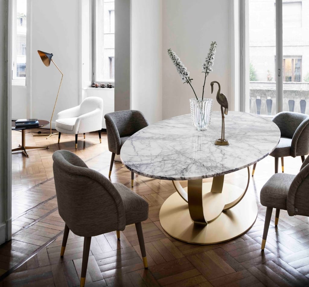 Marble top gold base round dining table with upholstered chairs by Dom Edizioni