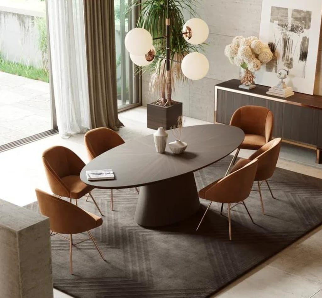 Brown lacquered round top dining table with orange upholstered chairs